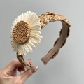 Detailed close-up of woven raffia headband featuring a large straw sunflower ornament - Sunflower + Khaki Woven Headband