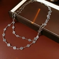 Close-up of a silver double-layer necklace featuring intricate hollow clover leaf pendants - Necklace - Silver Rhombus Flower