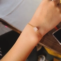 Minimalist gold chain bracelet featuring a natural irregular raw pink crystal stone - Rose Quartz