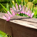 Detail of pink crystal moon crown with hand-wrapped metal wire on a wooden surface - Pink Crystal with Silver Wire & Moon
