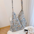 Detailed view of the small floral pattern and shoulder strap design on a cotton tote bag - White Base Blue Pink Yellow Small Flowers