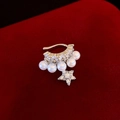 Silver star earring with double-layered zircon and pearls on red velvet background - Left Ear / Silver