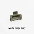 Detail of a matte beige grey hollow rectangular hair claw clip with a frosted finish - Matte Beige Grey