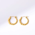 Detail of gold heart hoop earrings featuring connected 3D hearts on white background - Gold Heart Hoop Earrings
