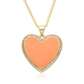 Close-up of golden necklace with orange enamel heart pendant and white zircon inlay - Orange Style (F150)