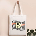 Detail of hanging white canvas tote bag with Spooky Season text and ghost print - Ghost Season