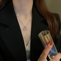 Elegant silver heart necklace and butterfly ring set worn on model with dark suit - Silver Twisted Heart