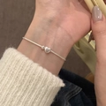 Elegant silver snake chain bracelet with a polished heart pendant on a female wrist - Silver Polished Heart Snake Chain (MY32592)