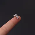 Silver 16G barbell earring with three vertically set clear zircons shown on fingertip - Silver Barbell Three-Stone Style (354-8#S)
