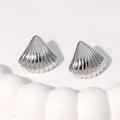 Polished silver shell stud earrings in 18K gold plated stainless steel on wavy surface - Steel