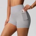 Detail view of high-waist yoga shorts featuring a side pocket with a smartphone - Frost Grey