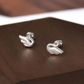 Elegant silver swan stud earrings with polished finish on a wooden display stand - Swan Shape Stud Earrings (A92)