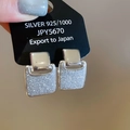 Macro shot of 925 silver square stud earrings with half polished and half glitter finish - Double-layer Geometric Square / Silver