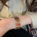 Nahaufnahme des Retro-Silberarmbandes mit Sternanhängern und braunem Emaille-Inlay - #25 Silberstift - Silber - Rot - Braun