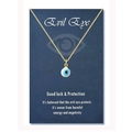 Detailed view of the Evil Eye pendant with blue eye charm and golden fine chain - 18K Gold White Bead (Black-Blue Eye)