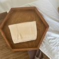 Beige knitted neck warmer for children made of soft wool displayed on a wooden tray - Solid Beige