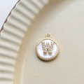 Detailed macro view of a gold-plated letter W shell pendant with inlaid cubic zirconia - W Round