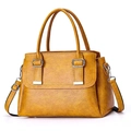 Elegant yellow faux leather square handbag with dual handles and adjustable shoulder strap - Yellow