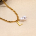 Elegant gold-tone L-letter necklace featuring a baroque pearl on champagne fabric - Letter L Necklace