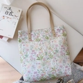 Borsa tote in tela a fiori con manici in pelle distesa accanto a un libro sui gatti - Foglia Verde Chiaro e Fiore Rosa Arancio
