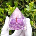 Orgonite pyramid with pink quartz tree and purple amethyst base held in white gloves - 66 / 5cm