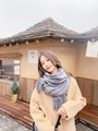 Elegant woman wearing a soft grey cashmere-style knit scarf with fringe and beige coat - Light Gray