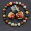 Macro view of natural mookaite jasper stone beads and polished raw gemstones texture - American Picture Jasper