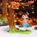 Ancient style Xi Shi girl figurine sitting on a swing with orange and blue outfit - Xi Shi Swing Figurine