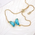 Detail of blue crystal butterfly pendant on adjustable gold bolo chain bracelet - Sky Blue