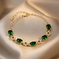 Vintage gold-tone bracelet featuring emerald green oval stones and floral zircon links - Green Oval Gemstone Style (1#)