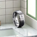 Close-up of men's titanium steel ring with single stone setting and grooved texture - Size 7 / Silver