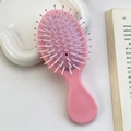 Pink bow-knot air cushion hairbrush for kids featuring an oval massage brush head - Sakura Pink Minimalist - Handle Comb