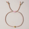 Pink and blue woven cotton bracelet with gold cross pendant and adjustable pull cord - Rainbow Bohemian Cross