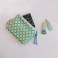 Macro detail of floral cotton storage pouch with light blue rope zipper and woven label - Light Yellow Flowers
