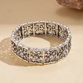 Close-up of vintage silver floral bracelet with rhinestone inlay and elastic cord - Hollow Floral Style With White Rhinestone / Silver