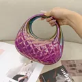Detailed close-up of holographic purple acrylic clutch bag with quilted diamond pattern - Purple & Green