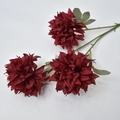 Macro shot of three dark red artificial dahlia heads with realistic green stems and leaves - Burgundy