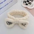 Creamy white plush OMG bow headband for face washing with black embroidery detail - Off White