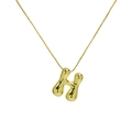 Macro view of polished 18k gold puffy bubble letter H pendant on a box chain necklace - Letter H