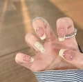 Detail of cream yellow French press-on nails with bow and rhinestone accents - 30 Pieces / Sweet Pink Apricot