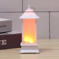 Detail of white Christmas lantern with warm LED flame light on wooden tabletop - White
