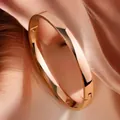 Detail of 6mm wide gold-tone domed stainless steel bangle with clasp mechanism - Simple Domed Surface (Rose Gold) / 6mm Width