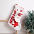 Close-up of white knitted Christmas stocking featuring Santa Claus and red plaid tree - White Knit Tree Pattern Stocking