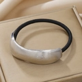 Detail of silver brushed metal hair tie with black elastic band on golden satin - Silver Single Layer Striped