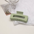 Close-up of matte Morandi green square claw clip on a minimalist white aesthetic setup - Cube / Bean Green