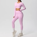 Detail showing side pocket of high-waist pink yoga leggings and long sleeve crop top set - Sakura Pink