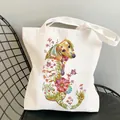 White canvas tote bag featuring an artistic dachshund print with colorful flowers and butterflies - C9 Floral Dachshund