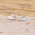 Minimalist silver ghost stud earrings in stainless steel on a stone texture background - Floating Ghost / Steel