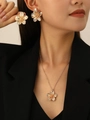 Detail of golden wrinkled texture flower earrings and necklace set worn by a model - Gold Flower Earrings + Necklace Set