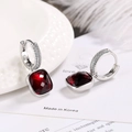 Detail of square red zircon earrings with S925 silver pave setting on white background - Red